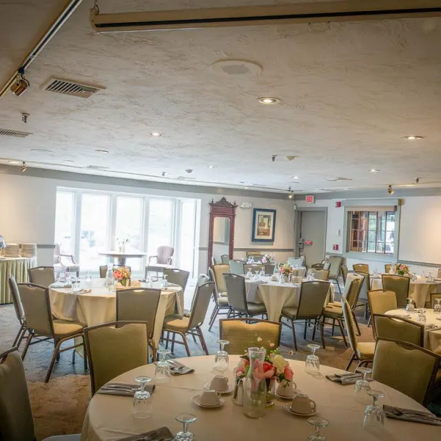 Elegant banquet room with round tables set for dining
