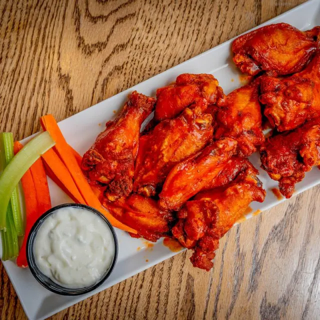 Bone-in wings with celery and carrot sticks